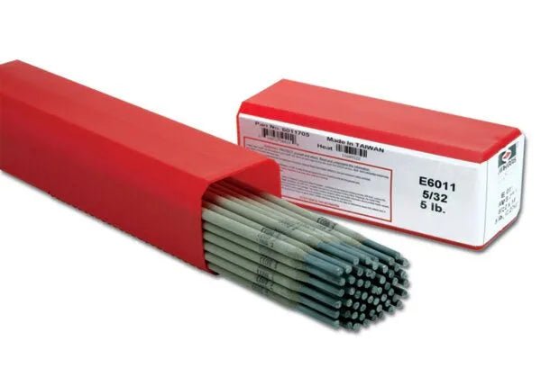 A partially open red box reveals Harris 6011 Stick SMAW Electrode 5/32 rods inside. An identical closed box marked 6011705 sits nearby—ideal all-position steel electrodes—both resting on a plain white background.