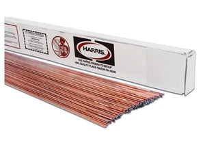 A partially open box labeled Harris displays neatly aligned copper-colored Harris ER80SD-2 Low Alloy Steel TIG GTAW Welding Rods (1/16, 10# PKG, 80SD230); packaging features a red logo, product info, and a handling warning in the upper left.