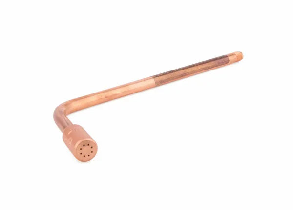 A copper L-shaped pipe with one end capped and featuring small holes arranged in a circular pattern on the cap, resembling an oxy-acetylene heating tip, isolated on a white background.