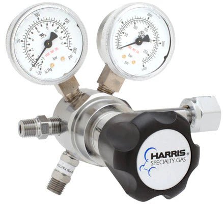 The Harris Two Stage Ultra High Purity Brass Barstock Regulator Model 721C-250-320-C features a metal body, dual pressure dials, black adjustment knob, stainless steel diaphragm, and fittings for gas line connections.