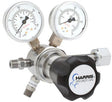 Shown is a Harris Two Stage Ultra High Purity Brass Barstock Regulator Model 721C-050-326-C, featuring two pressure gauges and a black knob labeled HARRIS SPECIALTY GAS, with steel fittings for cylinder connection.