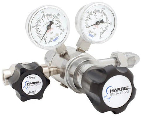 The Harris 742-050-580-A Argon/Helium/Neon/Nitrogen Regulator is a high-purity, two-stage stainless steel cylinder regulator with dual pressure gauges, OPEN/CLOSE control knob, threaded connectors, and Harris Specialty Gas branding.