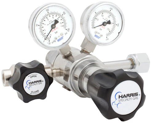The Harris 742-015-326-A Nitrous Oxide Regulator features two round pressure gauges with labeled dials and two black control knobs (one marked OPEN and CLOSE). This metallic, two-stage regulator ensures precise gas flow for specialty use.
