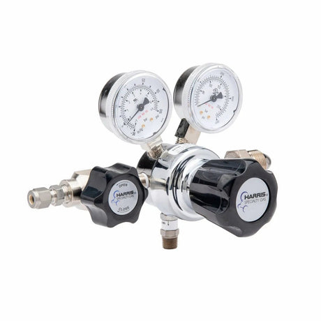 The Harris 701-050-580-BE regulator features dual psi/kPa gauges, large black adjustment knobs with visible branding, and multiple ports. Ideal for lab use with argon, helium, neon, or nitrogen gases.
