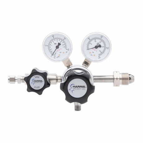 The Harris 701-125-590-BE Carbon Monoxide/Nitrous Oxide Regulator features two pressure dials and adjustment knobs, designed for precise gas flow control in laboratory or industrial environments.