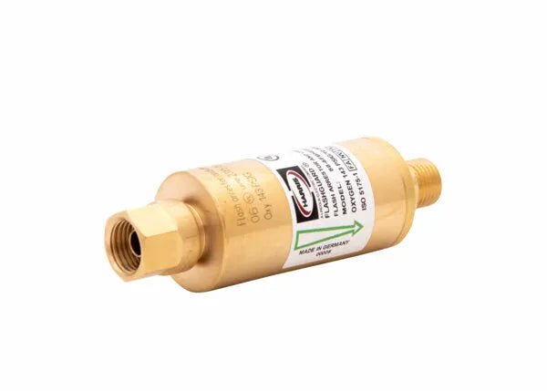Brass cylindrical oxygen flashback arrestor with threaded male and female connectors, labeled with product information and a green arrow indicating flow direction, placed on a white background.
