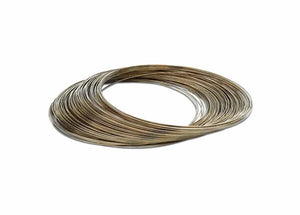 A 50 toz. coil of Harris 25350 Safety-Silv 25 high silver brazing alloy (1/16 in.) is laid flat on a white surface, forming tidy, overlapping loops with a slightly shiny, reflective finish.