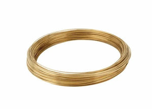 A neatly coiled loop of Harris 25350 - Safety-Silv 25 high silver brazing alloy (1/16 in., 1 ea., 50 toz. coil/box) with a smooth, metallic gold finish is arranged flat against a plain white background.