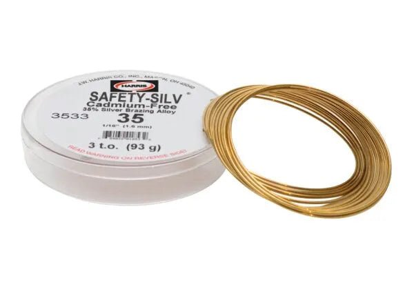 A spool of Harris 3533 Safety-Silv® 35 high silver brazing alloy, 1/16 in., 3 troy oz. (93g), gold-colored wire, displayed next to a white cup labeled with product details.