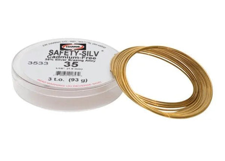 A spool of Harris 3533 Safety-Silv® 35 high silver brazing alloy, 1/16 in., 3 troy oz. (93g), gold-colored wire, displayed next to a white cup labeled with product details.