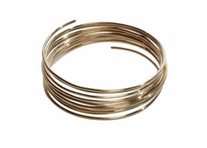 A coiled loop of Harris 4031 - Safety-Silv® 40 high silver brazing alloy wire (1/16 in., 1 toz. cup) is shown against a white background, cadmium-free with excellent corrosion resistance and slightly protruding ends.