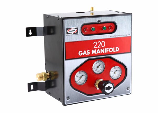 The Harris Series 220 Manifold - HPG_220 has a tamper-resistant case, three pressure gauges, control knob, indicator lights, and is labeled 220 Gas Manifold. Its black and silver design with red accents ensures easy identification.