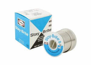 A spool of Harris SB831 Stay Brite 8 Lead-Free Solid Wire Solder (1/16 in, 4 lb) is shown next to its blue, white, and gray box, both angled slightly right. The solder is suited for plumbing applications.