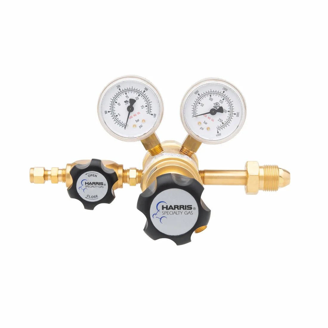 The Harris Two Stage Ultra High Purity Brass Barstock Regulator, Model 722-250-580-BE, features dual pressure gauges, labeled adjustment knobs, and fittings for gas flow control. Harris Specialty Gas branding appears on a knob.