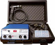 A portable plastic case containing a blue LYNX+ and LYNX4 electroejaculator device, cables, a control panel with digital display, a handheld probe, and a small clear box with compartments for accessories.