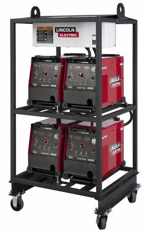 The Lincoln 4-PACK RACK FLEXTEC 450 K2956-2 is a black metal industrial rack on wheels holding four red Flextec 450 welders (two per shelf), with control panels visible and a white power distribution panel mounted on top.