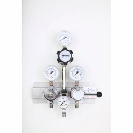 A Lincoln 4700260 Manifold 900BR1R361L36580 S/Over, featuring multiple gauges and knobs, is mounted on a white wall to provide precise control of gas flow and pressure readings as an essential fluid distribution component.