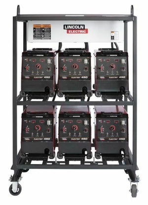 The Lincoln 6-PACK RACK FLEXTEC 450 K2957-2 is a portable metal rack on wheels holding six Flextec 450 welders, three per shelf, with heavy-duty inverter racks and the Lincoln Electric logo displayed at the top center.