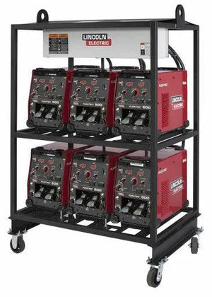 A metal wheeled rack holds six Lincoln 6-PACK RACK FLEXTEC 500 MULTI-PROCESS WELDER K4099-1 units in two rows of three, each with control dials, digital displays, and a white label with the Lincoln Electric logo—ideal for fabrication shops.