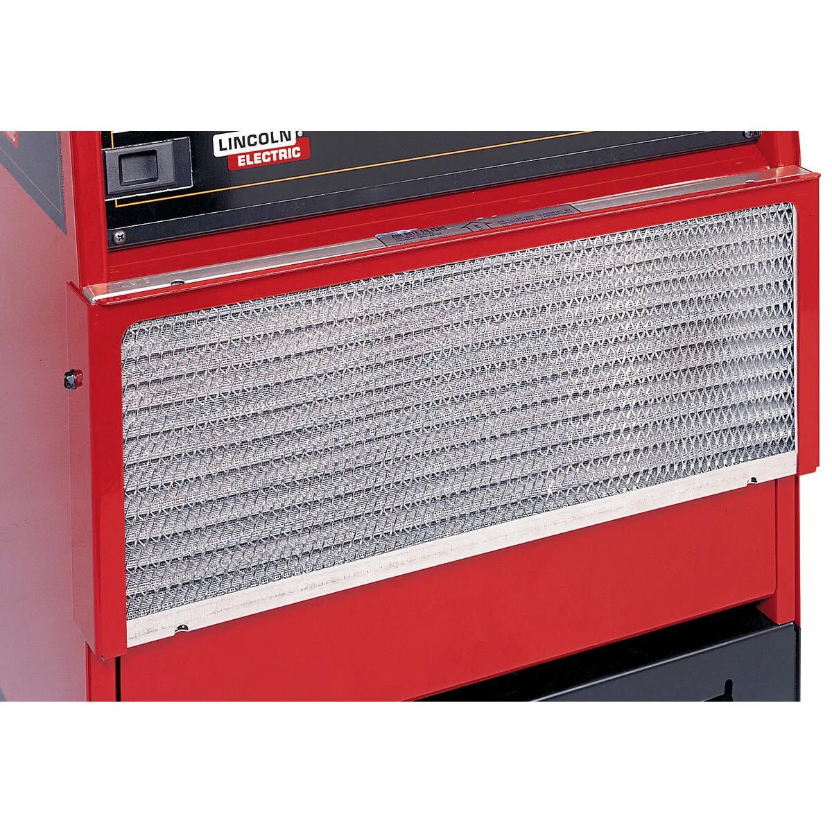 Close-up of a red industrial machine with a silver, diamond-mesh vent beneath part of the Lincoln Electric logo, featuring an all-metal air filter like the Lincoln Air Filter Kit K1486-1.
