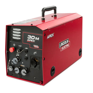 A red, rectangular Lincoln APEX 30M Mechanized Controller K52160-1 features a black control panel with knobs, switches, gauges, and a top handle. The brand and model names appear in white letters on the side.