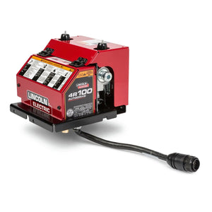 A red Lincoln AutoDrive 4R100 Wire Drive K3560-1 with a black base and handle is shown on a white background. It features the MAXTRAC Wire Drive System for robotic wire feeding, with labeled controls and a top chart.