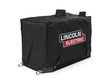 The Lincoln Ballistic Nylon Storage Cover K3588-1 is a black rectangular cover with handles and metal rings, made for the Ranger MPX welder. It features the white and red Lincoln Electric logo on the side against a plain white background.