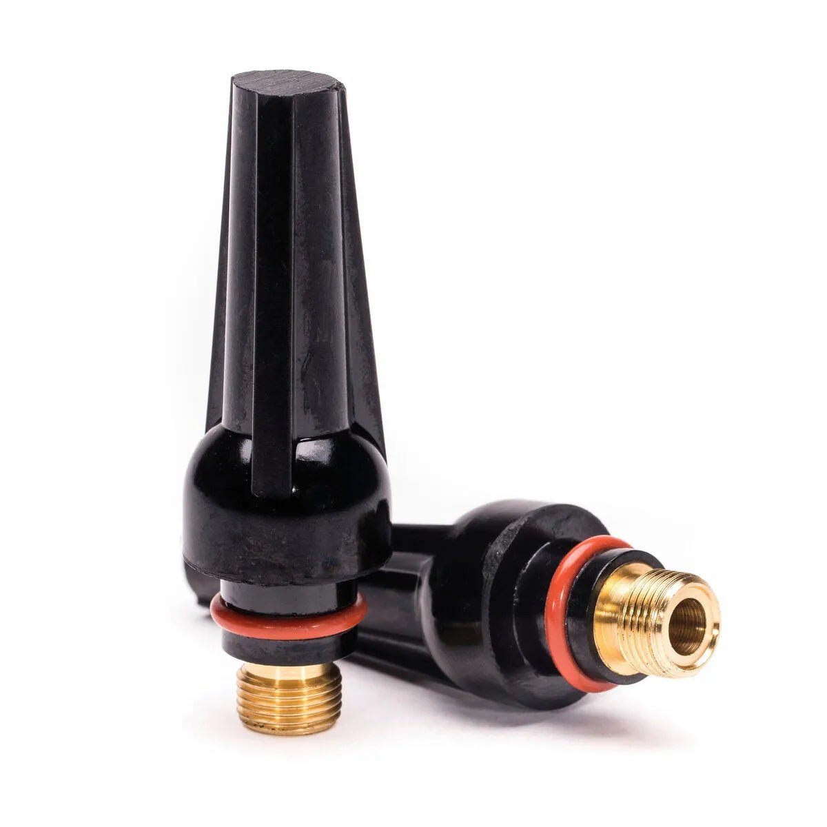 Two Lincoln Caliber Back Cap Mediums (KP4746-M) for 17/18/26 Torches are shown with red O-rings. Made of black plastic and brass, these 2-pack fittings hold the tungsten electrode securely in place on a white background.
