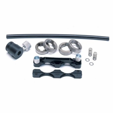 The Lincoln Drive Roll Kit .035 in (0.9 mm) Aluminum Wire KP1507-035A includes springs, washers, three metal rings, a black bracket, two silver knobs, a short black tube, a cylindrical adapter, and a flat tool displayed on a white background.