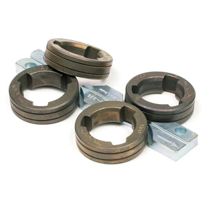 Five round steel thread rolling dies, including the Lincoln Drive Roll Kit .040-.045 in (1.0-1.1 mm) Cored Wire KP1505-045C with gear-like teeth, and three silver engraved rectangular metal blocks are arranged on a white background.
