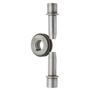 A metal gear with fine teeth and a central hole sits vertically between two cylindrical shafts, as included in the Lincoln Drive Roll/Guide Tube Kit .035in-.052in Solid Wire KP1899-3, all aligned on a white background.