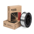 A 25 lb spool of Lincoln ED019294 Blue Max 308LSi MIG GMAW Stainless Steel Welding Wire (1/16 in) is upright beside two stacked, branded Lincoln Electric boxes. The wire is neatly wound on a black plastic spool against a white background.