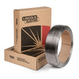 A 60 lb coil of Lincoln ED029207 Outershield 71 Elite 1/16 in FCAW-G welding wire stands upright beside two bold Lincoln Electric boxes, highlighting this premium flux-cored wire for welding solutions.