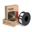 A spool of SuperGlaze 5554 aluminum welding wire sits in front of two cardboard Lincoln Electric boxes with black and red geometric designs on a white background.
