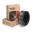 A spool of metal-cored welding wire sits upright in front of two stacked Lincoln Electric branded cardboard boxes with bold black and red graphics and text.