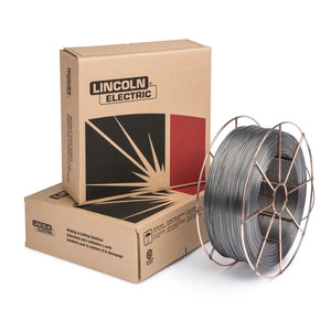 A spool of Innershield NR-305 FCAW-S flux-cored welding wire is placed beside two brown Lincoln Electric boxes, one upright and one lying flat, with bold black and red graphics on the packaging.