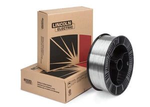 A 33 lb spool of Lincoln ED037302 Blue Max 316LSi MIG GMAW Stainless Steel Welding Wire (0.035 in) stands upright beside two stacked brown Lincoln Electric boxes with red and black graphics, highlighting excellent corrosion resistance.