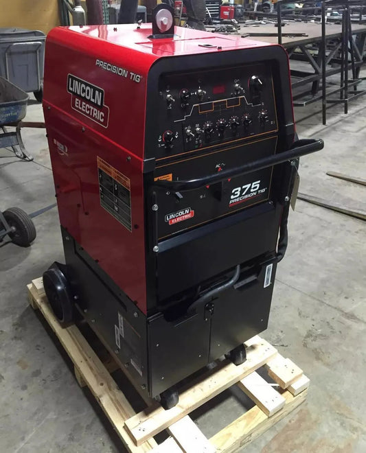 Lincoln Precision TIG 375 Ready-PAK welding machine U2624-1 on pallet in workshop, with control knobs and digital displays.