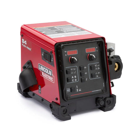 A red Lincoln Flex Feed 84 Single Bench K5000-3 wire feeder with a digital control panel, multiple knobs, buttons, side handle, labeled front spool compartment, and support for arc gouging (no wire reel stand).