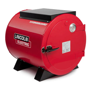 The Lincoln HydroGuard Bench Welding Rod Oven 240/480 V K2942-2 is a large, red, cylindrical oven with black supports, black top, side handle, gauge, and white label for stick electrode storage and moisture resistance on a plain white background.