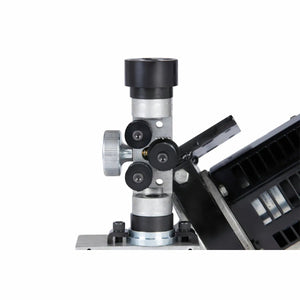 Close-up of the Lincoln MAXsa 29 Feed Head K2312-2, showing a metal clamp with three black rollers, a large silver adjustment knob, and part of the black motor housing—demonstrating precise wire feed speed control—against a white background.