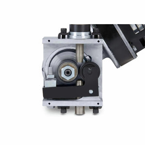 Close-up of a mechanical assembly with gears, a black lever, metal rods, and bolts in a rectangular metal housing. On the right, part of the Lincoln MAXsa 29 Feed Head K2312-2 provides precise wire feed speed control against a white background.