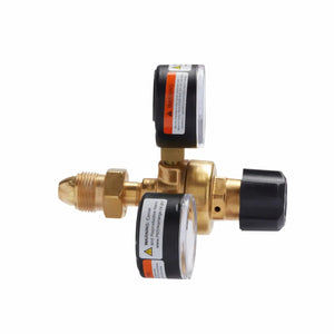 The Lincoln MIG Conversion Kit K610-2 includes a brass gas regulator with two round gauges (white faces, black edges), plastic adjustment knobs, and visible warning labels, shown on a white background. Compatible with MIG welding setups.