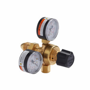 A brass gas pressure regulator for MIG welding, compatible with the Lincoln MIG Conversion Kit K610-2. Features two round white gauges, a black adjustment knob, warning labels, and threaded metal fittings for secure connections.