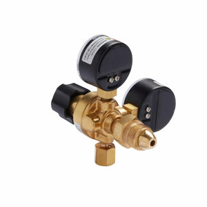 The Lincoln MIG Conversion Kit K610-2 brass gas regulator has two black pressure gauges, adjustment knobs, threaded connectors, and a central valve. It’s pictured at an angle on a white background and is ideal for MIG welding setups.