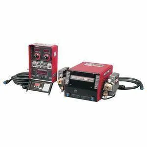 Two red industrial welding control units with attached cables, control knobs, switches, and digital displays are placed side by side, featuring Synergic CV MIG welding capabilities on a white background.