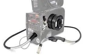 The Lincoln Power Feed 25M HyperFill Spindle Kit K5474-1 is shown with an attached dual spool feeder, cables, and a welding torch featuring a curved handle. The front panel includes switches and a digital display.