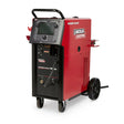 The Lincoln Power Wave 300C Standard - K4487-1 is a red and black multi-process welder on two wheels, featuring advanced waveform control, a digital control panel with screen and buttons, a top handle, front cable ports, and side branding.