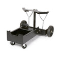 The Lincoln Precision TIG 225 Dual Cylinder Cart K2617-1 is a black metal cart with four wheels—two large rear and two front swivel casters. Its open frame supports an engine block, while chains on the upper arms secure the load.