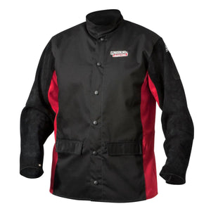 The Lincoln K2986-L Shadow Welding Jacket in large features black/red split leather sleeves, snap buttons, a high collar, two front pockets, and flame-retardant material. Displays the Lincoln Electric logo on the left chest and a sleeve patch.